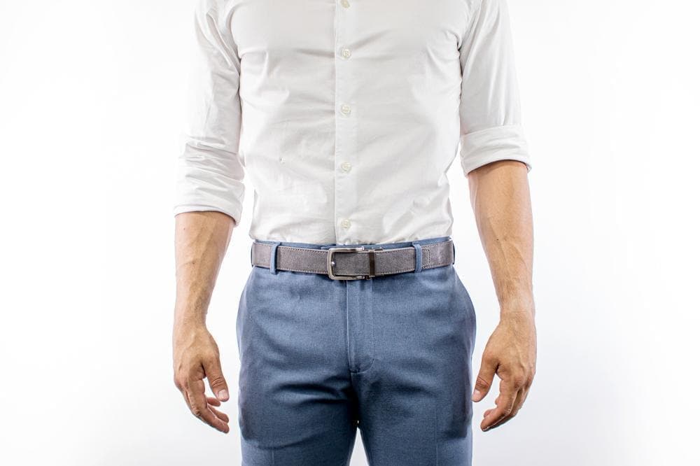 Man with belt, white shirt, and blue dress pants