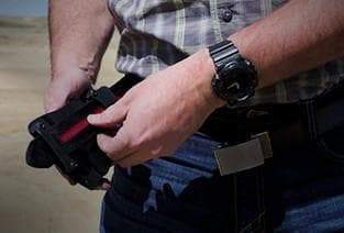Nexbelt tactical gun belt putting on a belt